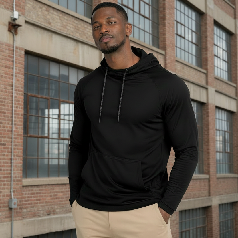 one man that is very muscular wearing the long sleeve athletic jacket with the triangle and circle inside it on the center of the shirt. the back ground is inside a modern home 
